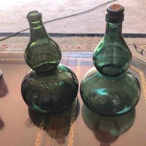 Two beautiful vintage glass bottles. One has flowers on it other is plain.